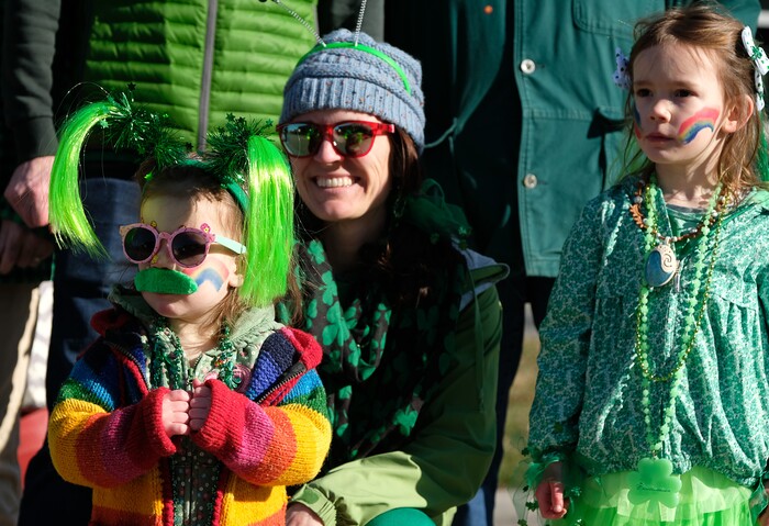 (Francisco Kjolseth | The Salt Lake Tribune) Amber Schiavone, center, takes in the fun alongside her daughters Mae, 2, and Sophia Robison, 5, as Salt Lake CityÕs Irish community celebrates their 41st annual St. PatrickÕs Day Parade with crowds lining up to take in the festivities. Marching bands, Irish dancers, bagpipes and a sea of green moved along 200 South, starting at 500 East Saturday morning en route to State street where the Siamsa festivities kept the fun going at the Gallivan Center.