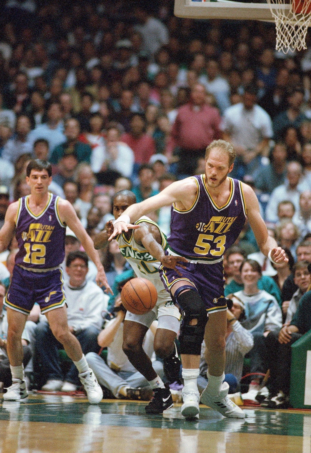 Gary Payton (20) of the Seattle SuperSonics reaches in from behind of knock the basketball away from Mark Eaton (53) of the Utah Jazz during the first quarter of their NBA playoff game, Friday, April 30, 1993, Seattle, Wash. (AP Photo/Robert Sorbo)