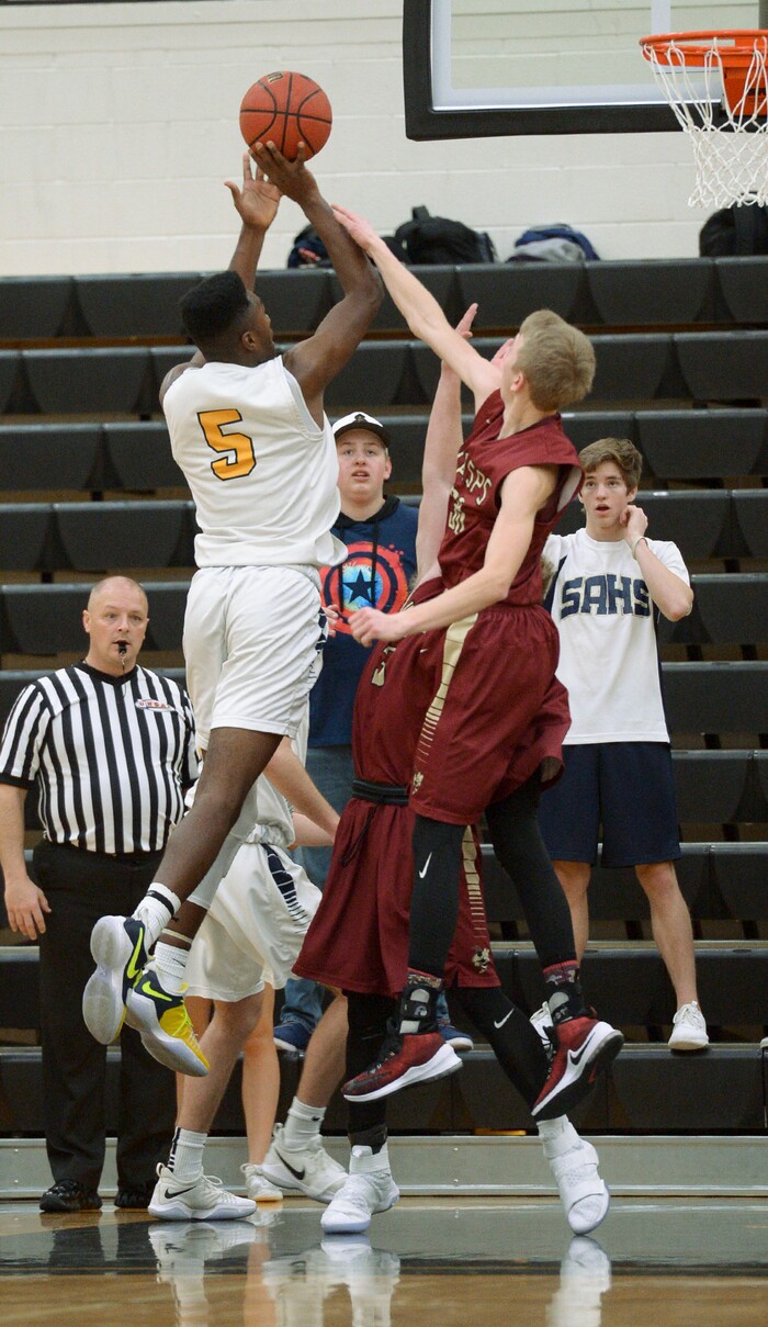 (Leah Hogsten  |  The Salt Lake Tribune) Juab's Kollin Robertson tries to stop Summit's Jalexus Gilson. Juab High School boys' basketball team defeated Summit Academy 61-58 during their 3A State tournament game in Heber  Saturday, Feb. 16, 2018.