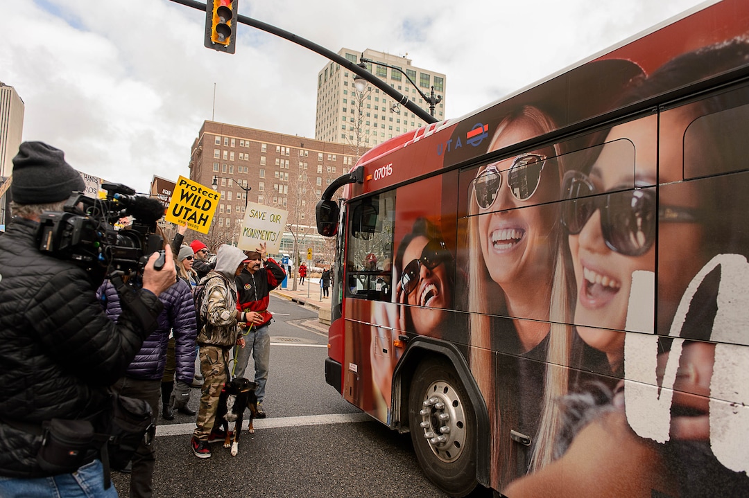 (Trent Nelson | The Salt Lake Tribune)  Protesters let a bus through an intersection they had blocked off downtown after a rally against a visit by President Donald Trump, Monday December 4, 2017.