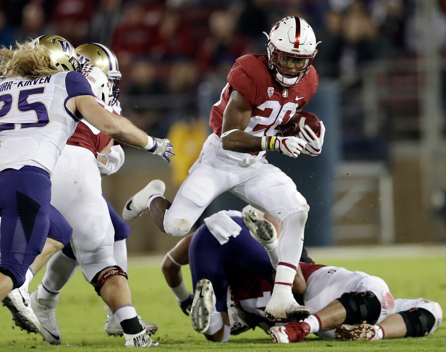 FILE - In this Nov. 10, 2017, file photo, Stanford 's Bryce Love (20) runs against Washington during the first half of an NCAA college football game, in Stanford, Calif. Love was selected to the AP All-Conference Pac-12 team announced Thursday, Dec. 7, 2017. (AP Photo/Marcio Jose Sanchez, File)