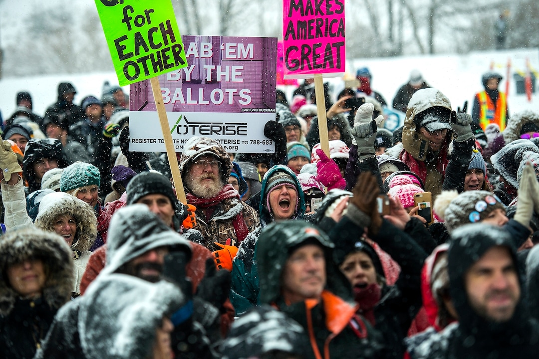 (Chris Detrick  |  The Salt Lake Tribune)  People hold signs and cheer during the Respect Rally Park City at City Park on Saturday, Jan. 20, 2018.