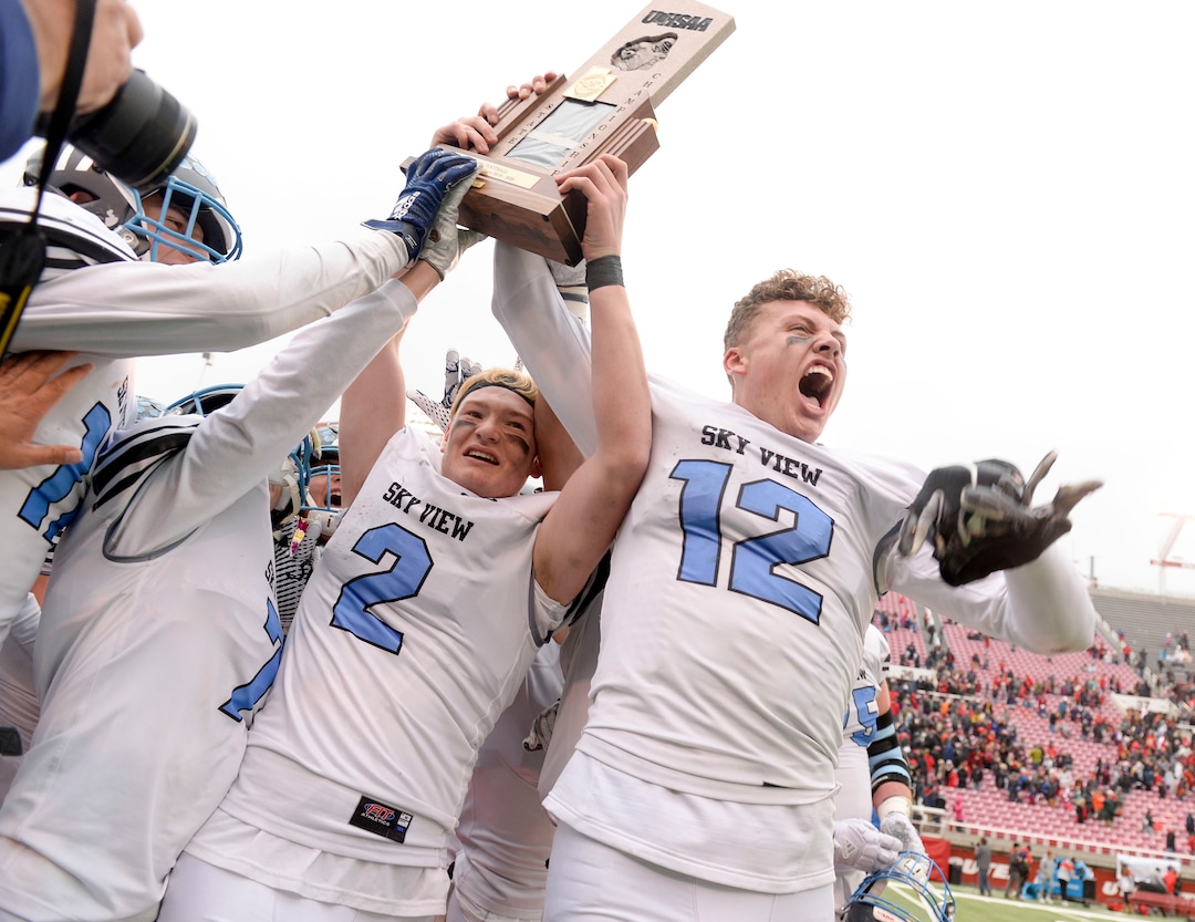 (Leah Hogsten  |  The Salt Lake Tribune) Sky ViewÕs quarterback Kason Carlsen and Mason Falslev celebrate the win with the team. Sky View High School defeated Park City 35-0 to win the 4A State Championship football title, Nov. 11, 2019 at Rice-Eccles Stadium.