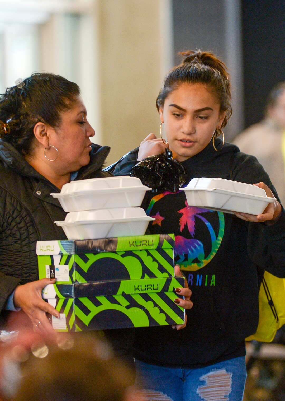 Leah Hogsten  |  The Salt Lake Tribune  Tina Torrez and her daughter Alex Torrez were loaded down with shoe boxes and food containers after eating a Thanksgiving meal at the Utah Jazz and the Larry H. Miller Group sponsored annual “We Care – We Share” benefit for local homeless and low-income families, Monday, Nov 19, 2018.