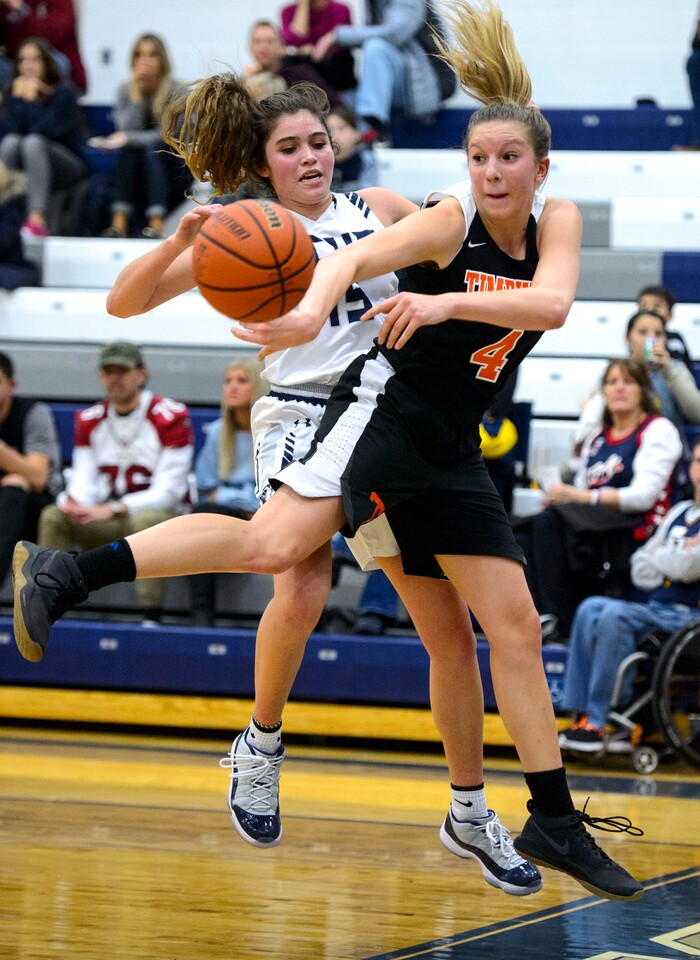 (Steve Griffin  |  The Salt Lake Tribune) Timpview's Ella Pope saves the ball in front of Corner Canyon's Nicole Critchfield during game at Corner Canyon High School in Draper Tuesday January 16, 2018.