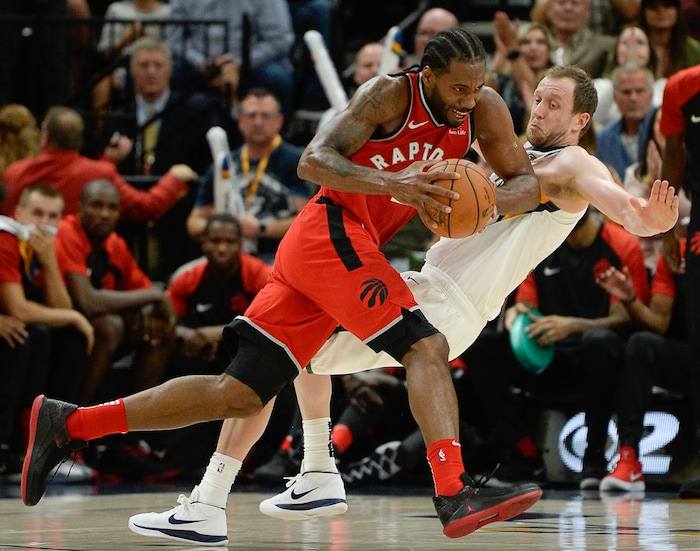 (Francisco Kjolseth  |  The Salt Lake Tribune)  Toronto Raptors forward Kawhi Leonard (2) plows over Utah Jazz forward Joe Ingles (2) in the first half of the preseason NBA game at Vivint Smart Home Arena Tuesday, Oct. 2, 2018, in Salt Lake City.