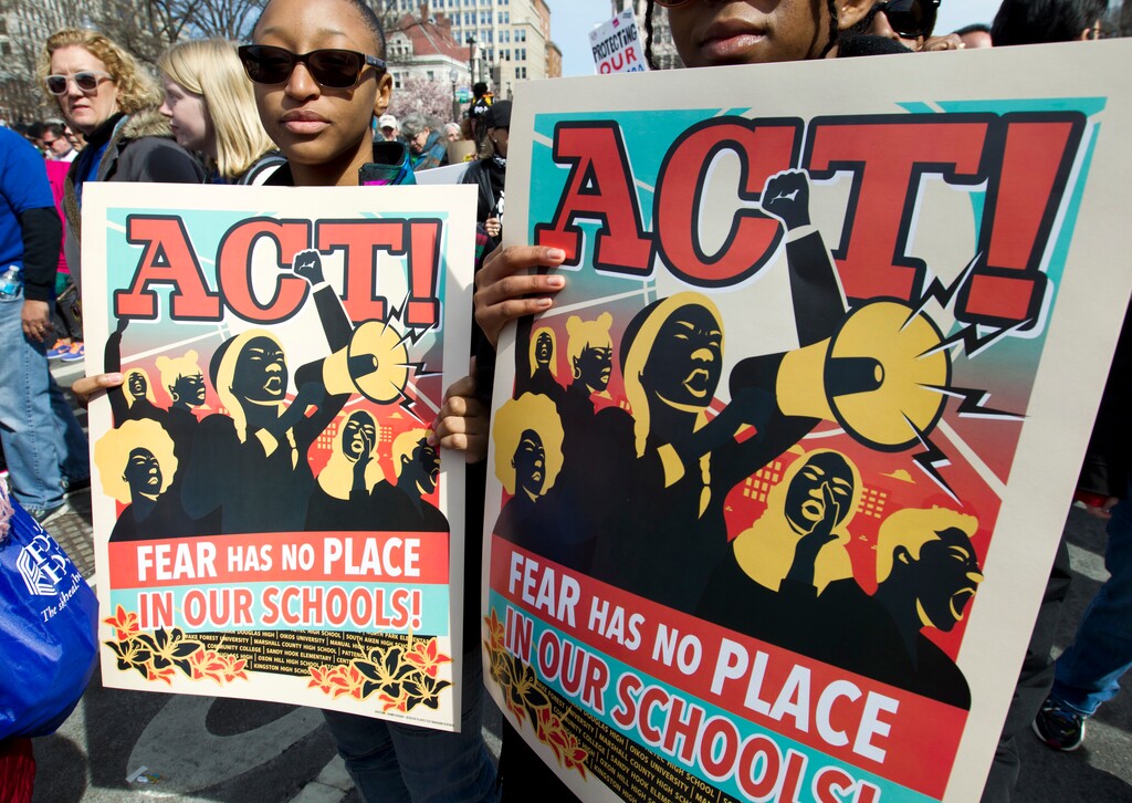 Protesters hold signs during the "March for Our Lives" rally in support of gun control in Washington, Saturday, March 24, 2018, on Pennsylvania Avenue near the U.S. Capitol. (AP Photo/Jose Luis Magana)