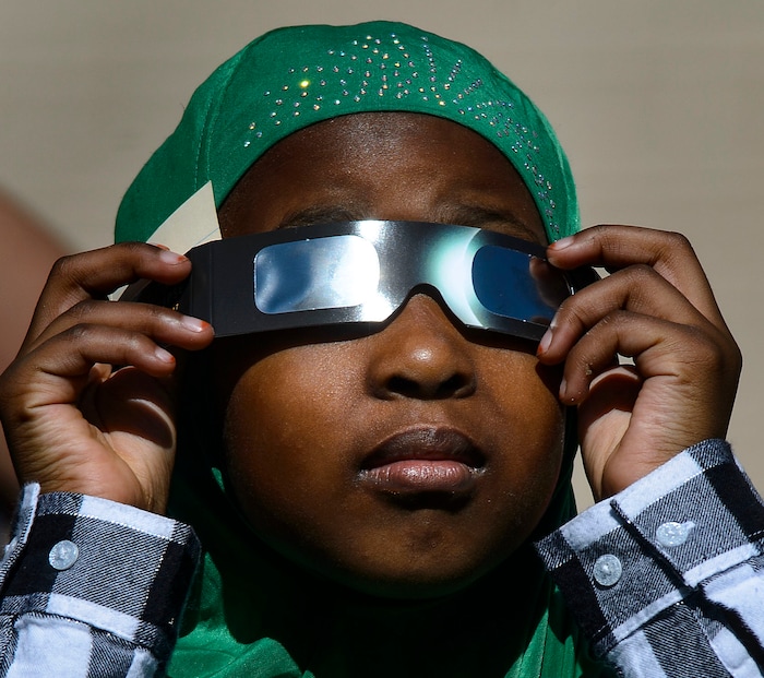 (Steve Griffin  |  The Salt Lake Tribune) Meadowlark Elementary School first-grader Fartun Musa watches The Great Eclipse during the Salt Lake School District's first day of the 2017-2018 school year. STEAM teacher-coordinator Wendi Laurence who formerly worked at NASA has been planning an event around the eclipse. All students had glasses to view the event and many had lunch outside at the Salt Lake City school Monday August 21, 2017.
