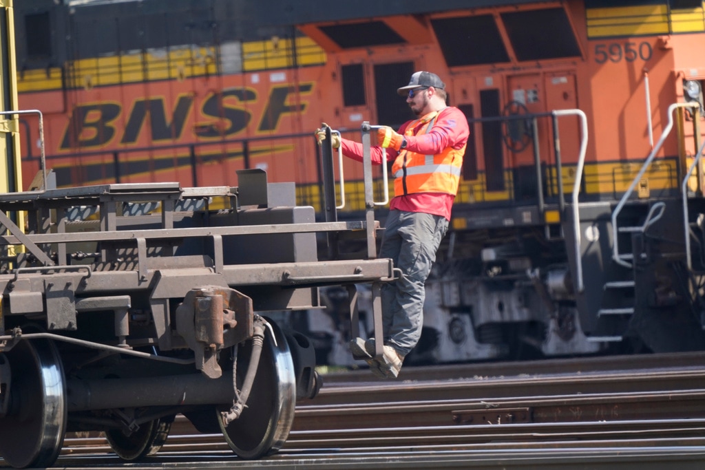 (LM Otero | AP file photo) A worker rides a rail car at a BNSF rail crossing in Saginaw, Texas, Wednesday, Sept. 14, 2022. Tens of thousands of engineers remain frustrated with the lack of paid sick time and the demands railroads like BNSF are making in negotiations despite the progress that has been made in 2023 with sick time deals for most of the other rail unions.