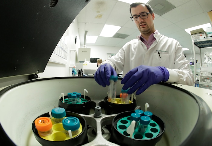 (Ted Warren | AP file photo) Pierce Prozy uses a centrifuge for CBD vape oil test samples at Flora Research Laboratories in Grants Pass, Ore., on July 18, 2019. The Associated Press commissioned the lab to test vape products marketed as delivering the cannabis extract CBD. AP chose the samples by targeting brands that law enforcement authorities or users flagged as suspect. Ten of the 30 samples contained synthetic marijuana, a dangerous street drug commonly known as K2 or spice.