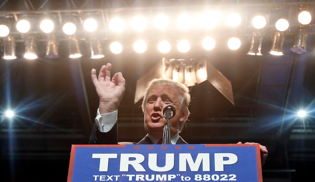 FILE - In this May 5, 2016 photo, Republican presidential candidate Donald Trump gestures during a rally in Charleston, W.Va.  Despite what Trumps campaign describes as comprehensive background checks, Trump has failed to detect problems with his partners _ including ex-cons, a man fleeing bankruptcy fraud charges and the scion of a family suspected by U.S. diplomats of Iranian money laundering.   (AP Photo/Steve Helber)