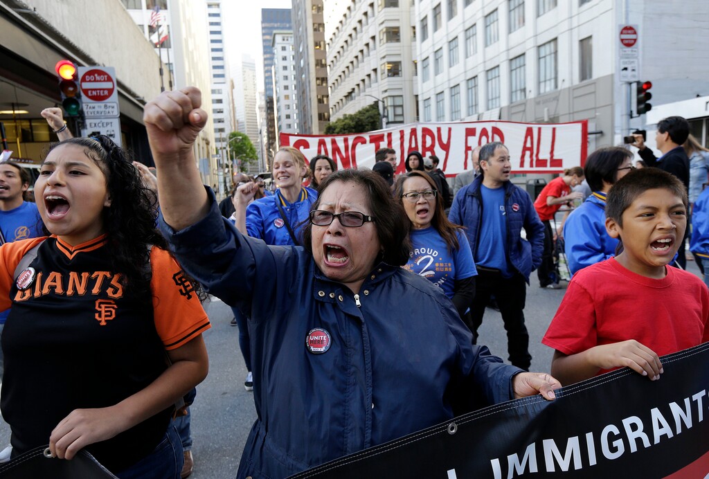 Guadalupe Chavez, center, and others yell during a protest outside of the U.S. Citizen and Immigration Services building in San Francisco, Monday, May 1, 2017. (AP Photo/Jeff Chiu)
