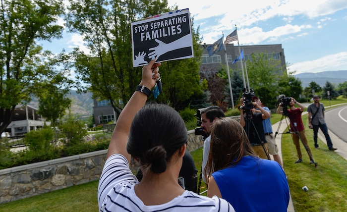 (Francisco Kjolseth  |  The Salt Lake Tribune)  Activists stage a protest against a private prison company with contracts to hold undocumented immigrants on Thursday, July 12, 2018, at the headquarters of Management and Training Corporation in Centerville.