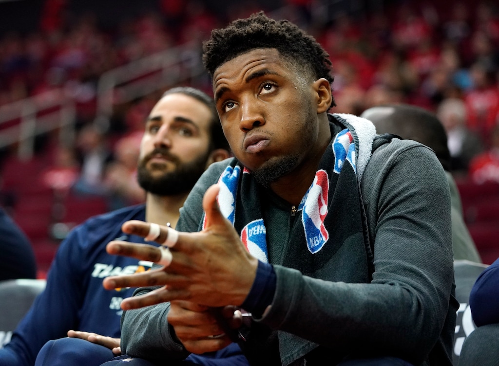 Utah Jazz guard Donovan Mitchell, right, watches the final moments of Game 2 of a first-round NBA basketball playoff series against the Houston Rockets in Houston, Wednesday, April 17, 2019. At left is Jazz guard Ricky Rubio. The Rockets won 118-98 and lead the series 2-0. (AP Photo/David J. Phillip)