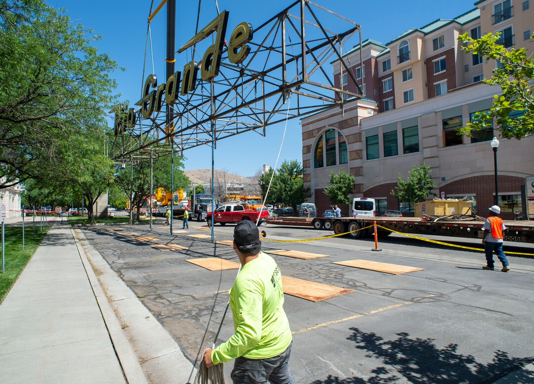 (Rick Egan  |  The Salt Lake Tribune)     The  neon Rio Grande sign that has shined from the rooftop of the Rio Grande Depot for more than 50 years is removed from the building, Monday, Aug. 12, 2019.
