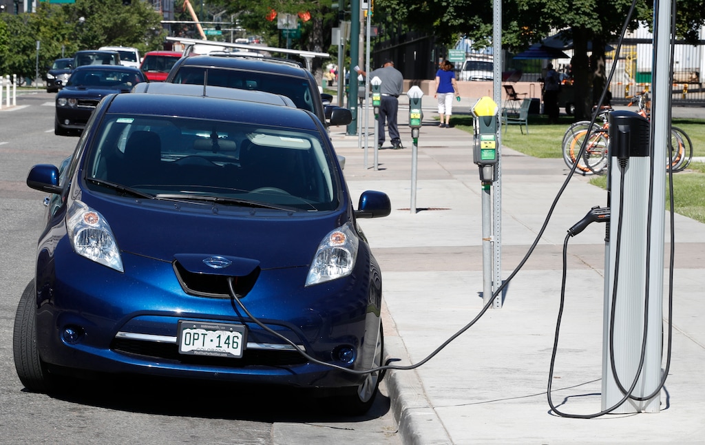 (David Zalubowski | AP file photo) A Nissan Leaf charges at a recharge station while parked by the Denver City County Building in downtown Denver in 2018. Electric and hybrid cars in Utah will be able to participate in a program that charges them a fee for miles driven, up to the maximum they would face for other registration fees imposed because they escape gasoline tax.