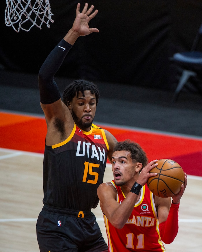 (Rick Egan | The Salt Lake Tribune) Atlanta Hawks guard Trae Young (11) looks for a shot as Utah Jazz center Derrick Favors (15) defends, in NBA action between the Utah Jazz and the Atlanta Hawks at Vivint Arena, on Friday, Jan. 15, 2021.