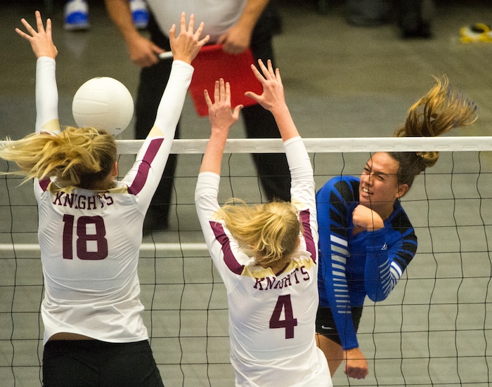 (Rick Egan  |  The Salt Lake Tribune)   Pleasant Grove Vikings Kazna Tarawhiti (16) hits the ball, as Pleasant Grove Vikings Megan Sintay (18) and Alia Rasmussen (4), defend, in 6A volleyball championship action, Pleasant Grove vs. Lone Peak, at Utah Valley University, Saturday, November 4, 2017.