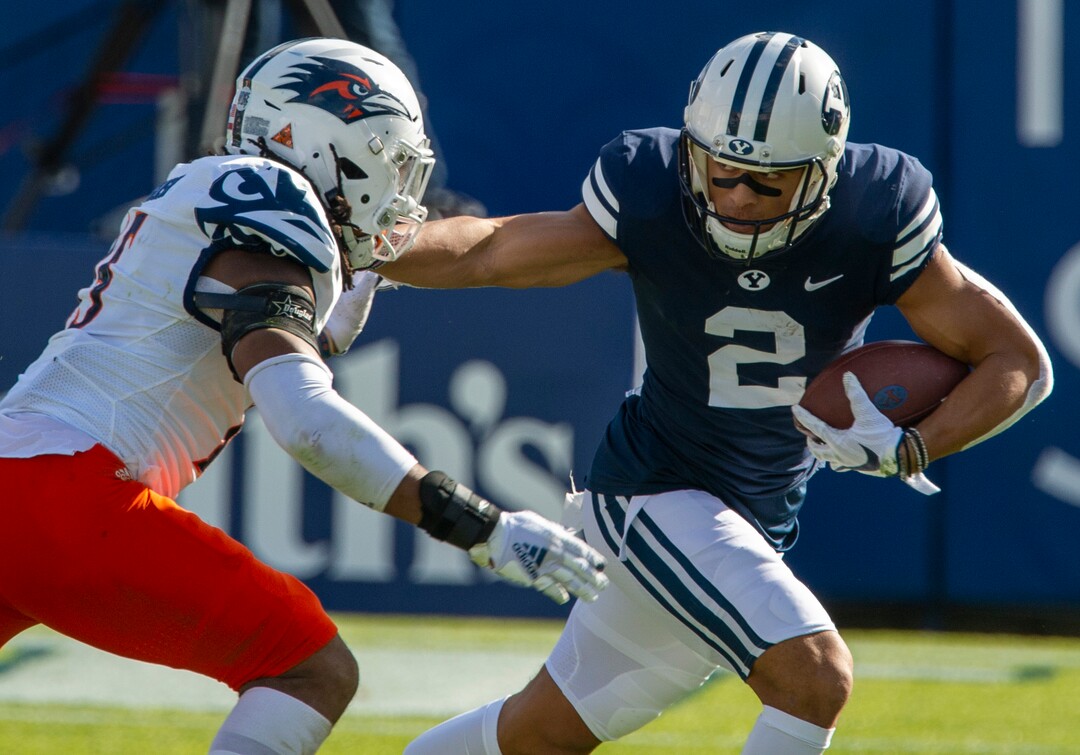 (Rick Egan  |  The Salt Lake Tribune)   Brigham Young wide receiver Neil Pau'u (2) runs the ball for the Cougars, as Roadrunners linebacker Trevor Harmanson (15) defends, in football action between the Brigham Young Cougars and the UTSA Roadrunners, at Lavell Edwards stadium, Saturday, Oct. 10, 2020.