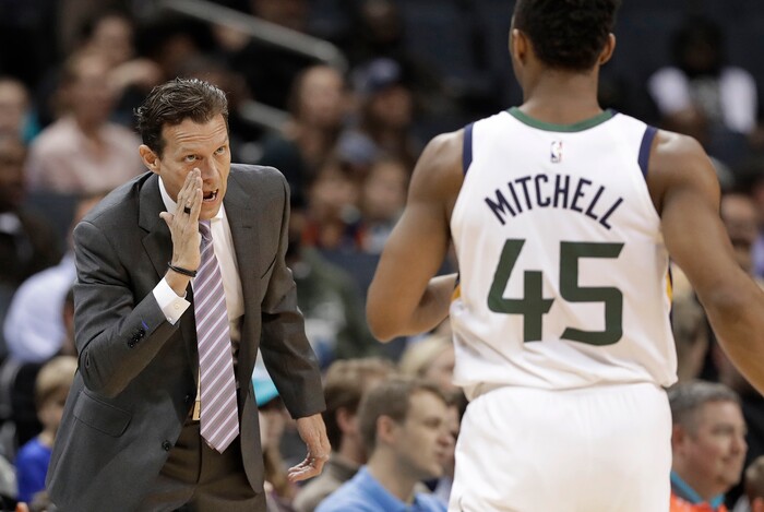 Utah Jazz coach Quin Snyder, left, talks with Donovan Mitchell (45) during the first half of the team's NBA basketball game against the Charlotte Hornets in Charlotte, N.C., Friday, Jan. 12, 2018. (AP Photo/Chuck Burton)