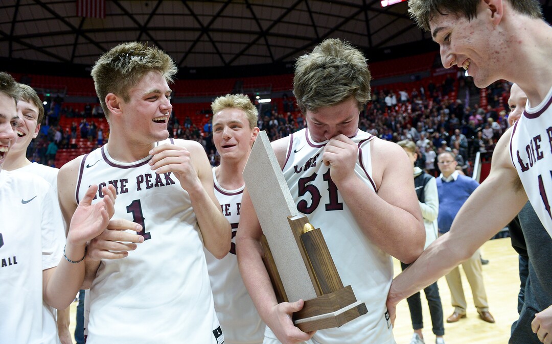 (Leah Hogsten  |  The Salt Lake Tribune) Lone Peak's Conner Pay (51) becomes emotional holding the trophy. Lone Peak defeated Pleasant Grove 61-44 to win the 6A High School BoysÕ Basketball Tournament Championship at the Jon M. Huntsman Center in Salt Lake City, Saturday, March 3, 2018. 