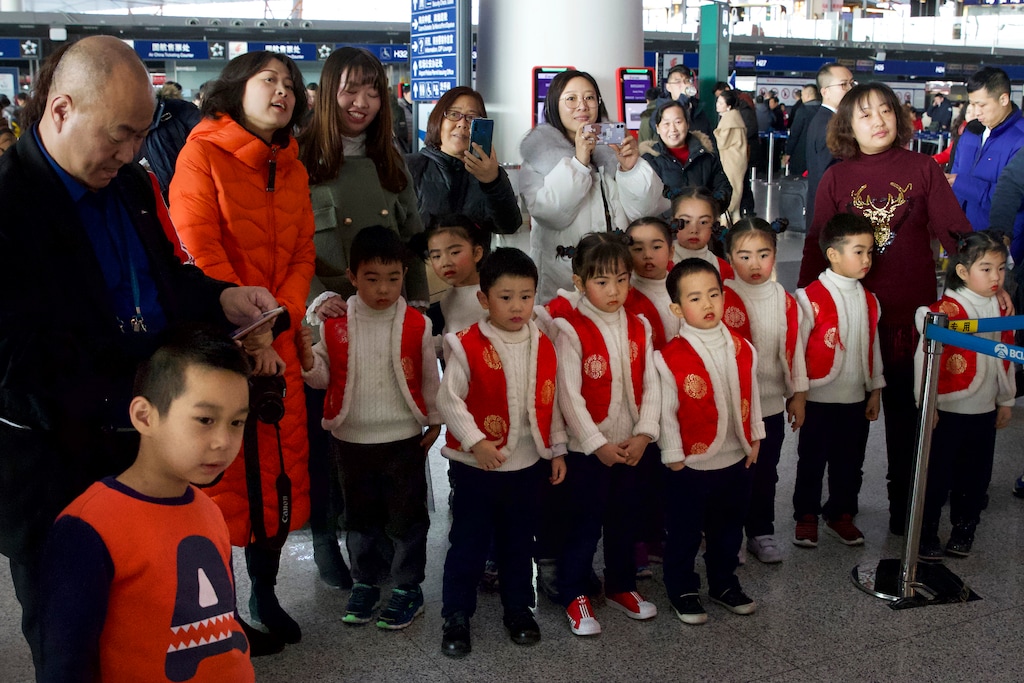 (Ng Han Guan | AP file photo) A group of children in costume wait to perform at Beijing Capital International Airport in Beijing, Friday, Jan. 17, 2020. China's population crept past 1.4 billion in 2019 for the first time, even as the birthrate continues to fall.