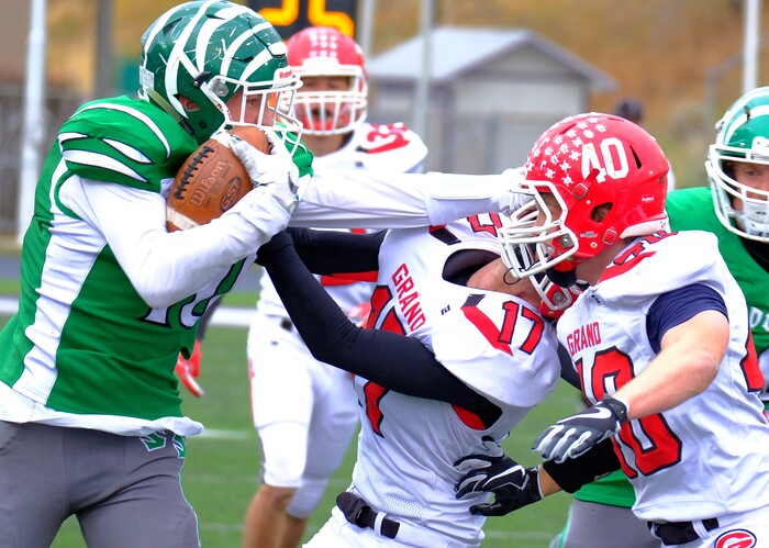 (Leah Hogsten  |  The Salt Lake Tribune) South Summit's Keegan Stacher strong arms Grand's Austin Johnson.  South Summit High School boys' football team leads Grand County High School 34-3 during their class 2A state semifinal football game Saturday, November 4, 2017 at Weber State University's Stewart Stadium.