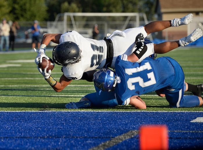 (Scott Sommerdorf | The Salt Lake Tribune) Corner Canyon RB Tai Gonzales gets the ball to the one yard line to set up QB Zach Wilson's first half TD run. Corner Canyon led Pleasant Grove 14-3 at the half, Friday, August 18, 2017.