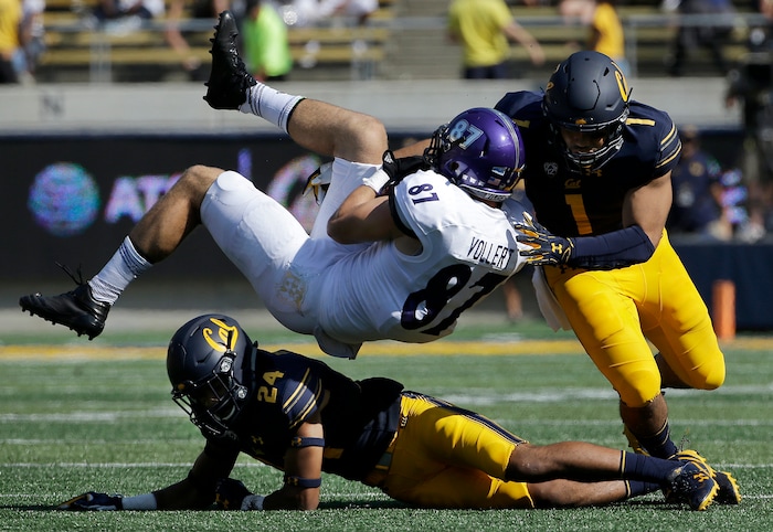 Weber State tight end Andrew Vollert (87) is tackled after catching a pass between California cornerback Camryn Bynum (24) and linebacker Devante Downs (1) during the first half of an NCAA college football game in Berkeley, Calif., Saturday, Sept. 9, 2017. (AP Photo/Jeff Chiu)