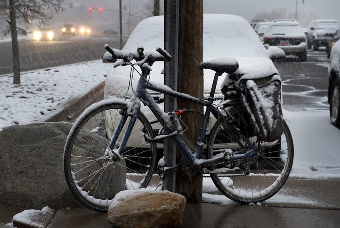 (Scott Sommerdorf | The Salt Lake Tribune)
A bicyclist will find their bike a little heavier when they return to it at the park and ride at the bottom of Big Cottonwood Canyon as snow falls, Wednesday, December 20, 2017.
