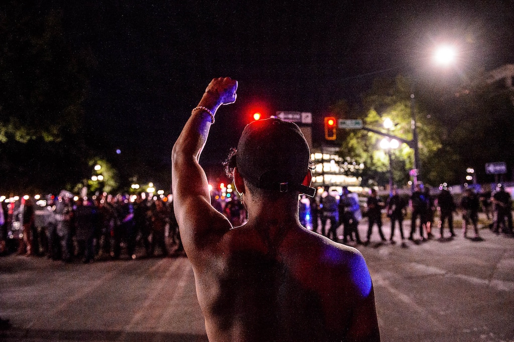 (Trent Nelson  |  The Salt Lake Tribune)  Protesters confront a line of police after a protest against police brutality turned violent in Salt Lake City on Saturday, May 30, 2020.