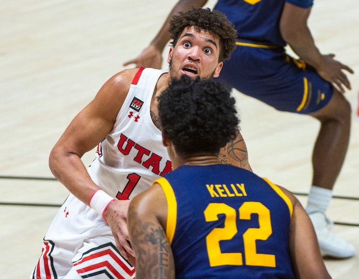(Rick Egan | The Salt Lake Tribune) Utah Utes forward Timmy Allen (1) goes to the basket as California Golden Bears forward Andre Kelly (22) defends, in PAC12 Basketball action between the Utah Utes and the California Golden Bears, on Wednesday, Jan. 16, 2021.