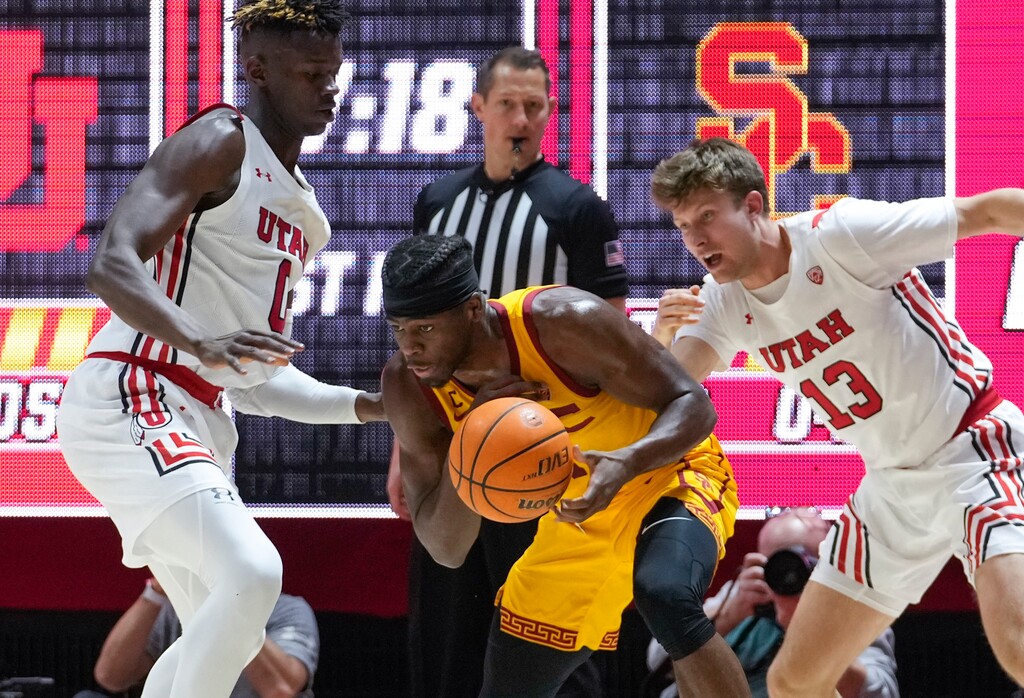 (Leah Hogsten | The Salt Lake Tribune) Utah Utes center Lahat Thioune (0) and Utah Utes guard Eli Ballstaedt (13) pressure USC Trojans forward Chevez Goodwin (1) as the Utes host the USC Trojans at the John Huntsman Center, Jan. 22, 2022. 