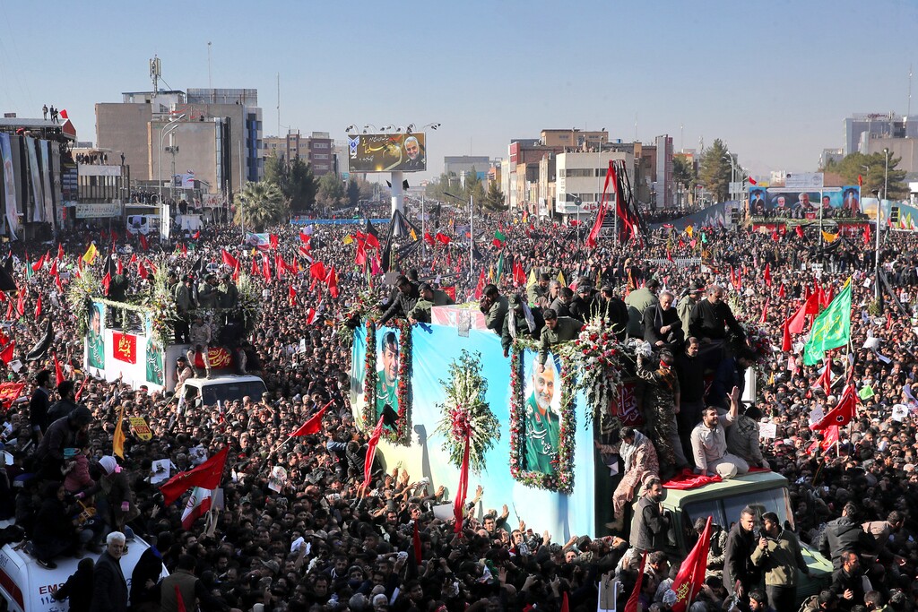(Erfan Kouchari | Tasnim News Agency via AP) Coffins of Gen. Qassem Soleimani and others who were killed in Iraq by a U.S. drone strike, are carried on a truck surrounded by mourners during a funeral procession, in the city of Kerman, Iran, Tuesday, Jan. 7, 2020. The leader of Iran's Revolutionary Guard threatened on Tuesday to "set ablaze" places supported by the United States over the killing of a top Iranian general in a U.S. airstrike last week, sparking cries from the crowd of supporters of "Death to Israel!"