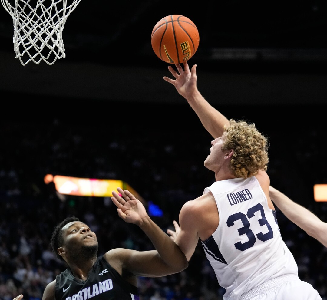 (Francisco Kjolseth | The Salt Lake Tribune) Brigham Young Cougars forward Caleb Lohner (33) sails over Portland Pilots guard Chika Nduka (15) in WCC basketball action between the Brigham Young Cougars and the Portland Pilots, at the Marriott Center, on Saturday, January 22, 2022.