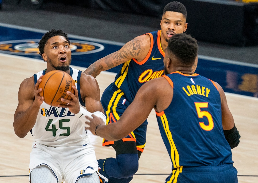 (Rick Egan | The Salt Lake Tribune) Utah Jazz guard Donovan Mitchell (45) looks for a shot as Golden State Warriors forward Kevon Looney (5) defends, in NBA action between the Utah Jazz and the Golden State Warriors at Vivint Arena, on  Saturday, Jan. 23, 2021.