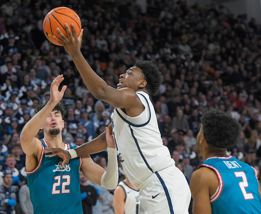 Utah State forward Great Osobor shoots the ball as New Mexico forward Mustapha Amzil (22) and guard Donovan Dent (2) defend during the first half of an NCAA college basketball game Saturday, March. 9, 2024, in Logan, Utah. (Eli Lucero/Herald Journal via AP)