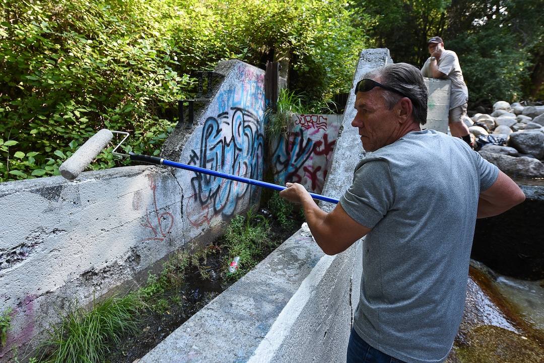 (Francisco Kjolseth  |  The Salt Lake Tribune)  Scott Whipperman covers up graffiti that has proliferated in lower Little Cottonwood Canyon, where vandals, often wielding cans of florescent-colored spray paint, have covered granite faces, trees and structures. The vandalism is particularly apparent along the Temple Quarry Trail and the creek at the Moon Rock swimming hole and former pavilion site. Volunteers using donated equipment and solvents spend thousands of hours removing the paint from the rocks only to see graffiti return to the same faces or on rock nearby.