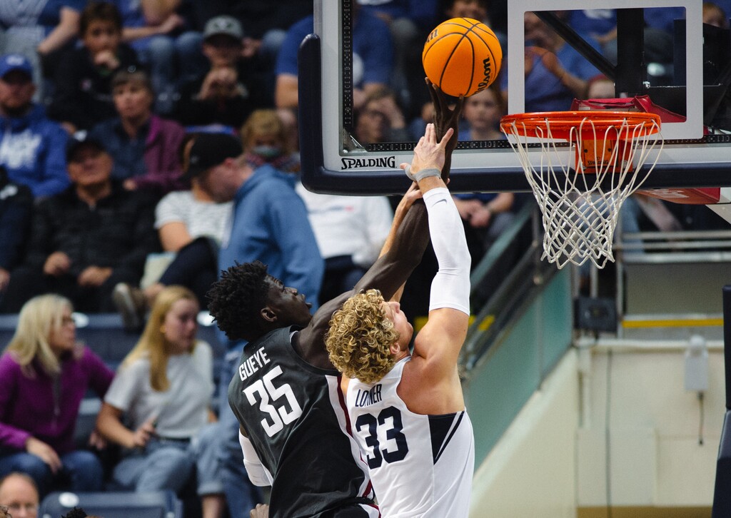 (Rachel Rydalch | The Salt Lake Tribune) Brigham Young Cougars forward Caleb Lohner (33) and Washington State Cougars forward Mouhamed Gueye (35) dual at the basket during the first quarter of the NIT quarter finals at the Marriott Center on Wednesday, March 23, 2022.