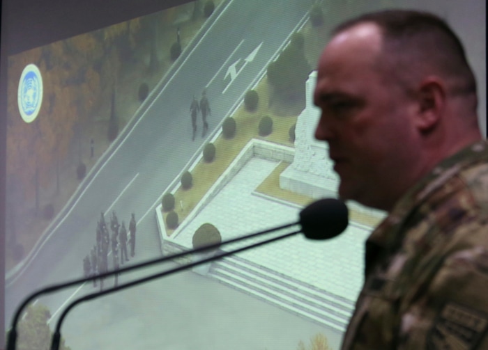 Col. Chad G. Carroll, a spokesman for the U.N. command, shows the CCTV footage regarding a North Korean soldier's defection during a press conference at the Defense Ministry in Seoul, South Korea, Wednesday, Nov. 22, 2017. A North Korean soldier made a desperate dash to freedom in a jeep and then on foot, being shot at least five times as he limped across the border and was rescued by South Korean soldiers, according to dramatic video released by the U.S.-led U.N. command Wednesday. (AP Photo/Ahn Young-joon)