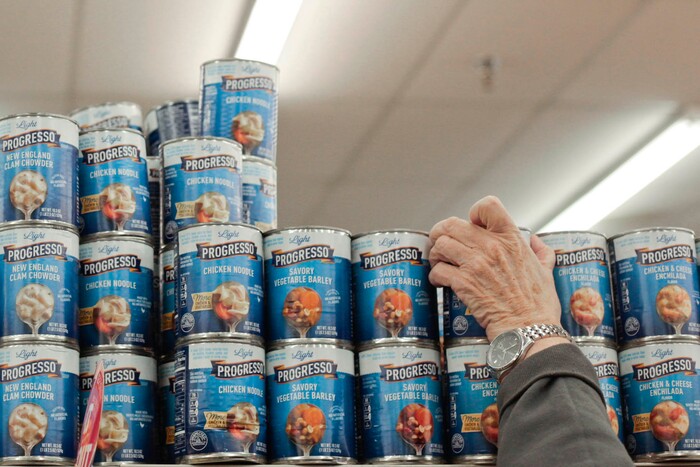 This photo taken Jan. 5, 2018, shows Felicity Varkevisser reaching up for a can of soup in the grocery story in Provo, Utah. (Evan Cobb/The Daily Herald via AP)