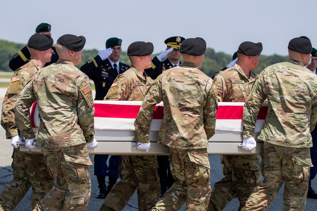 (Alex Brandon  |  AP Photo) U.S. Army Maj. Gen. E. John Deedrick, Jr., left, Chief Warrant Officer 5 David R. Holton, Maj. Gen. Donald E. Jackson, Col. Thomas P. Vogel, and Command Sgt. Maj. Kevin P. Dorsh, and Col. Dawn C. Lancaster, partially obscured, salute as an Army carry team moves a transfer case containing the remains of U.S. Army Sgt. 1st Class Elliott J. Robbins, at Dover Air Force Base, Del., Tuesday, July 2, 2019. According to the Department of Defense, Robbins, of Ogden, Utah, assigned to the 10th Special Forces Group died while supporting Operation Freedom's Sentinel.