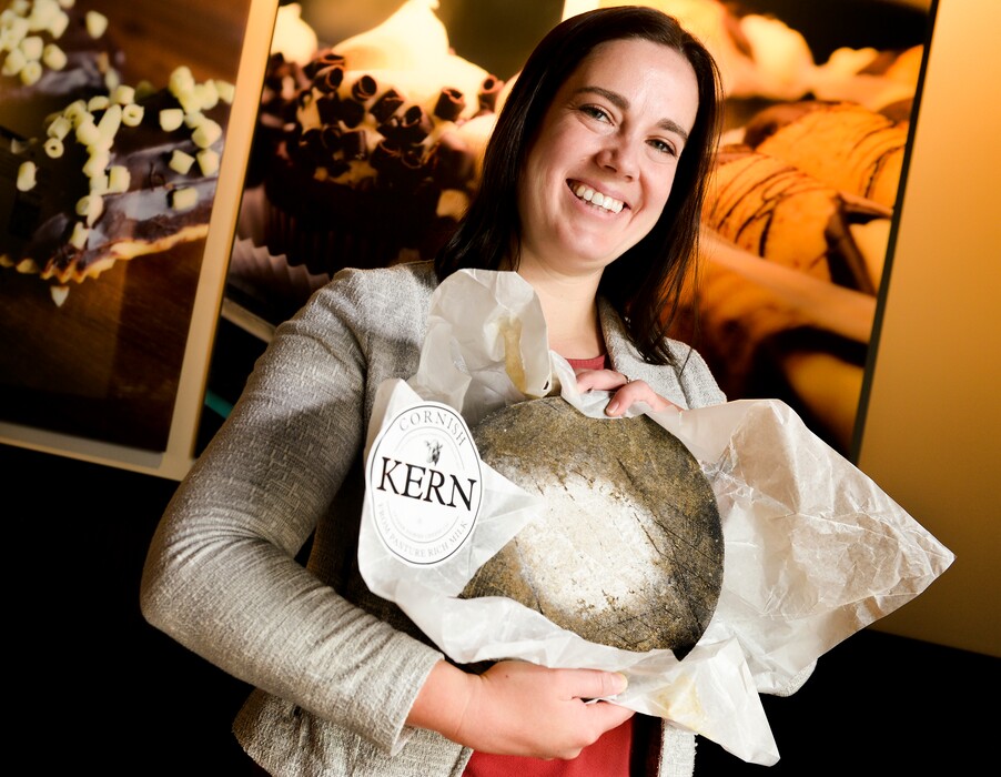 (Leah Hogsten | The Salt Lake Tribune) Harmons Grocery specialty cheese buyer Mariah Christensen holds a wheel of Cornish Kern, a cheese from the United Kingdom, that recently won best cheese in the world. Cornish Kern is available at Harmons grocery stores.