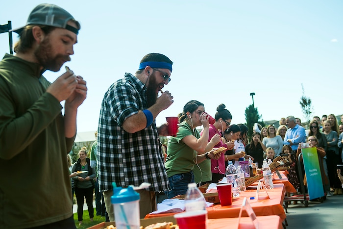 (Chris Detrick | The Salt Lake Tribune) Employees compete in a pizza eating competition during a fundraiser for United Way at CHG Healthcare Wednesday, September 20, 2017.