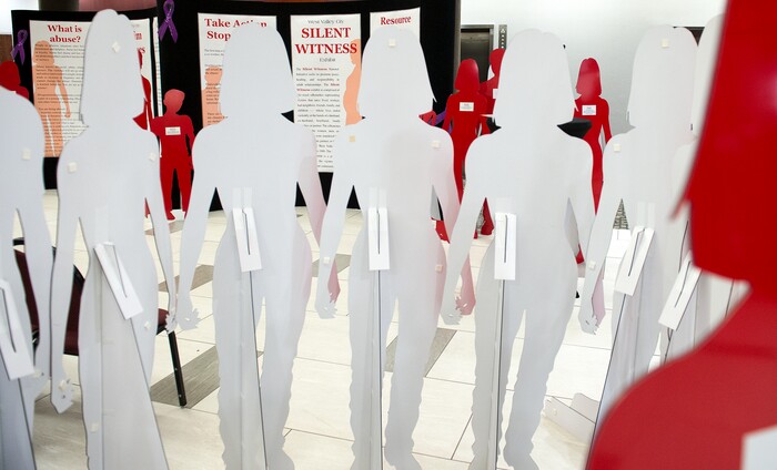 (Leah Hogsten  |  The Salt Lake Tribune)  Life-sized, red metal silhouettes serve as a reminder of victims of domestic-violence homicides during West Valley City's domestic violence-awareness march and reception at City Hall.