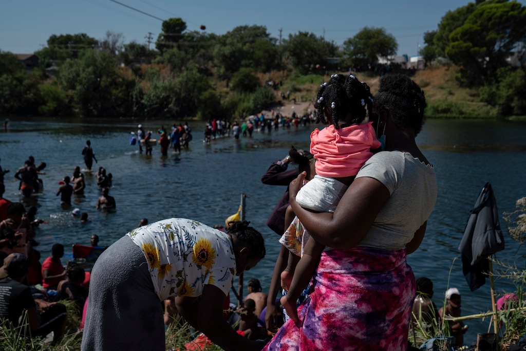 (Veronica G. Cardenas | The New York Times)

People seeking asylum are seen crossing the Rio Grande into Del Rio, Texas on Friday, Sept. 17, 2021. Haiti migration officials have asked the United States for a "humanitarian moratorium" even as they prepare to receive the first returnees from Texas. "Will we have enough to feed these people?"