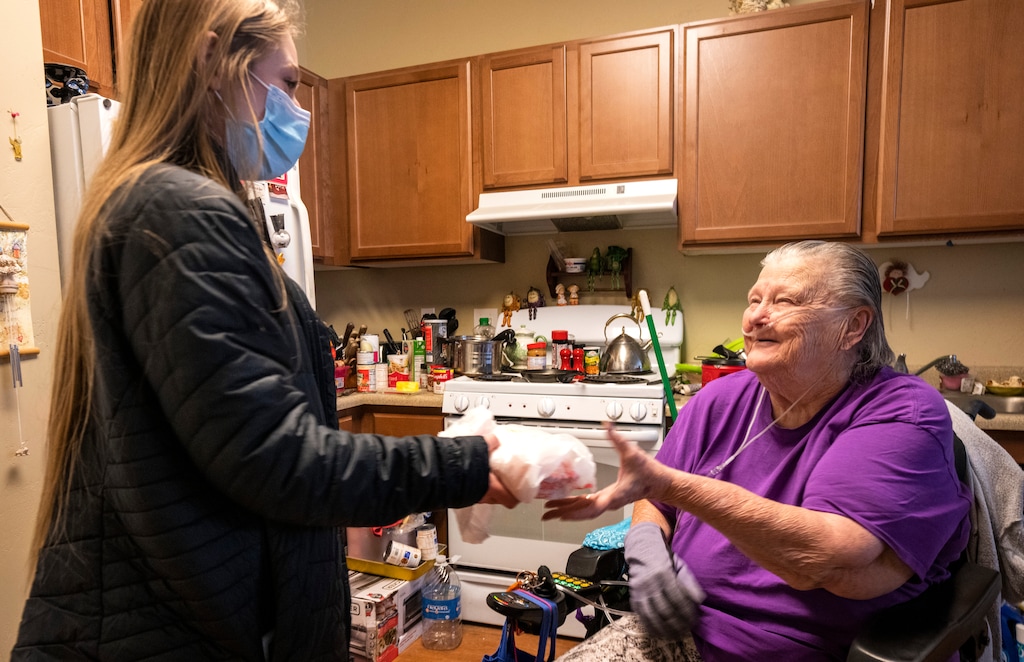 (Rick Egan | The Salt Lake Tribune) Ashley Roderick from Chefpanzee, delivers a meal to Gene Burns, at her apartment in West Jordan, on Friday, Jan. 7, 2022.