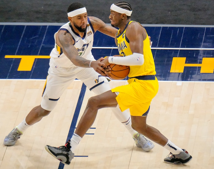 (Leah Hogsten | The Salt Lake Tribune) Utah Jazz forward Royce O'Neale (23) tries to strip the ball out of Indiana Pacers guard Caris LeVert (22) hands as the Jazz host the Pacers, Friday, April 16, 2021, at Vivint Arena.