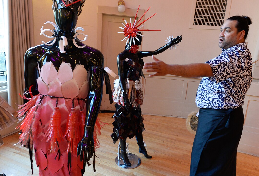 (Francisco Kjolseth  |  The Salt Lake Tribune)  Maafu Suliafu points out details in dresses he made completely out of recycled materials. The Pasifika Enriching Arts of Utah presents their 6th annual art exhibit at the Clubhouse, 850 E. South Temple on Saturday, Aug. 25, 2018, as part of Utah Pacific Islander Heritage Month to preserve culture and heritage through all types of mediums and disciplines.