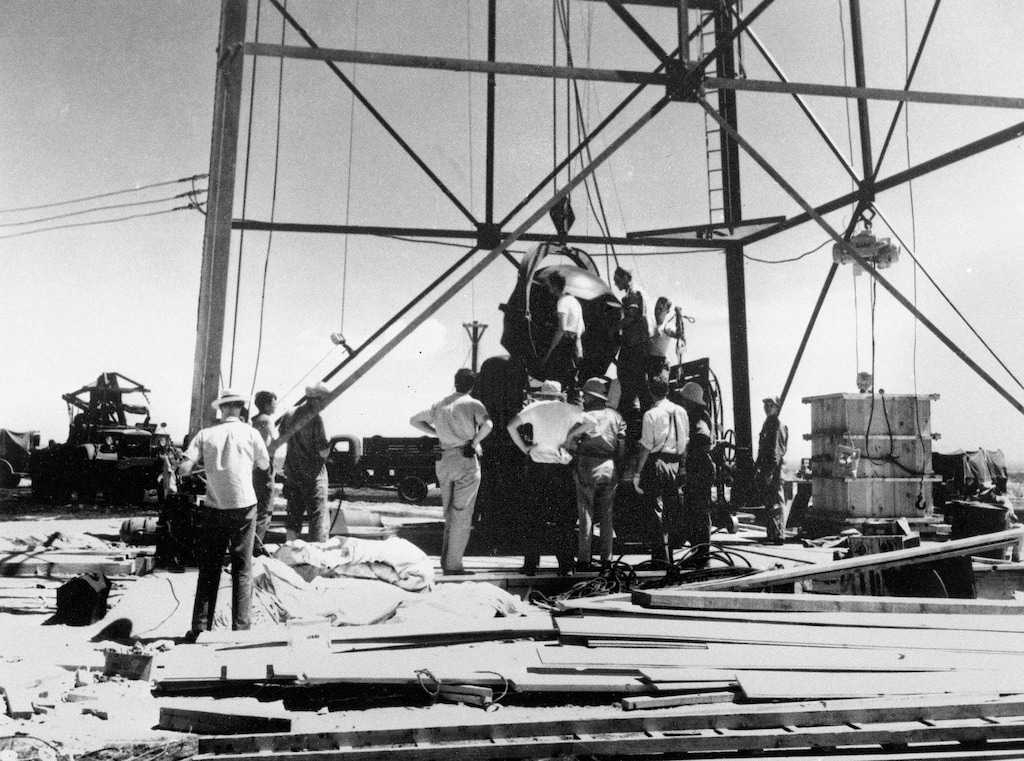 (The Associated Press) Scientists and other workers rig the world's first atomic bomb to raise it up onto a 100-foot tower at the Trinity Test Site near Alamagordo, N.M. A new film on J. Robert Oppenheimer's life and his role in the development of the atomic bomb as part of the Manhattan Project during World War II opens in theaters on Friday, July 21, 2023. On the sidelines will be a community downwind from the testing site in the southern New Mexico desert, the impacts of which the U.S. government never has fully acknowledged.